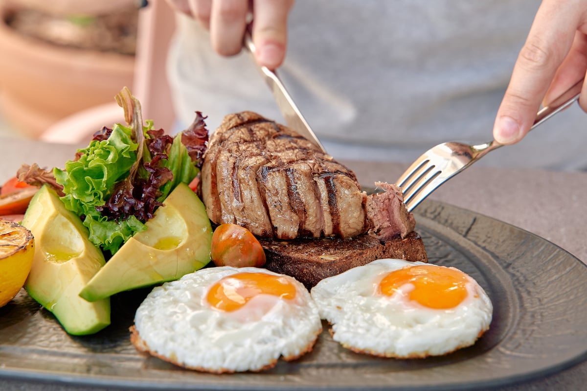 A beautifully cooked steak plated with fresh vegetables