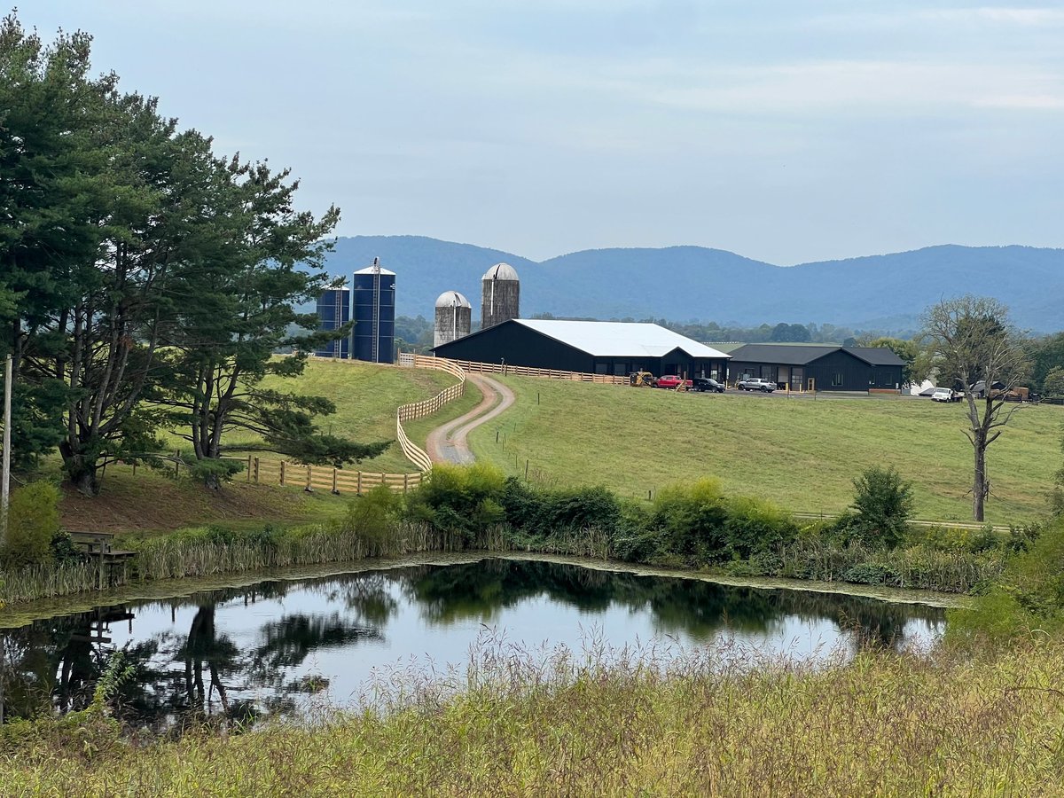 Pond, barns, silos, and rolling hills at Alaron Farms in North Garden, Virginia.